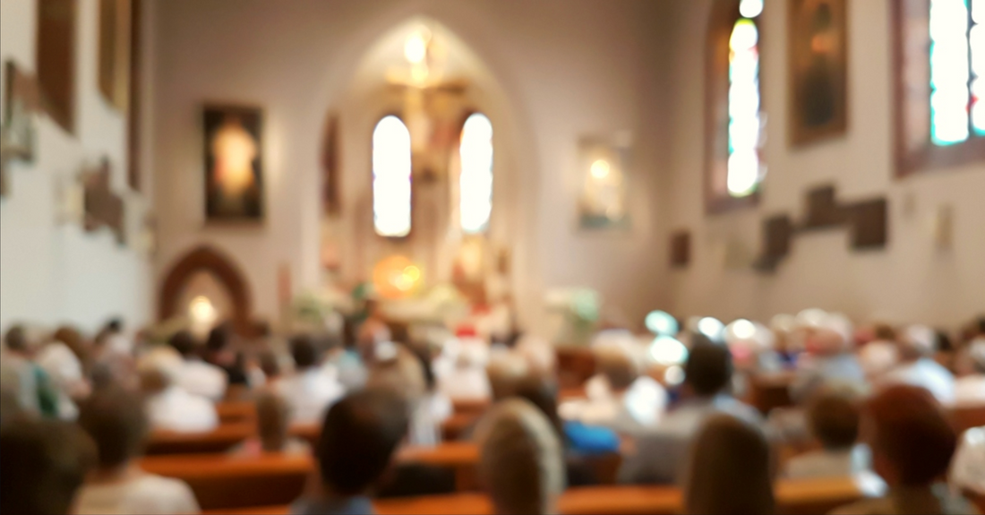 church with people in pews blurred out